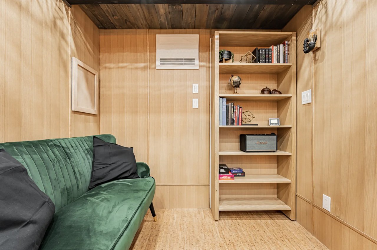 This Tiny Home has its own Indoor Porch that you access through a Hidden Bookshelf Door