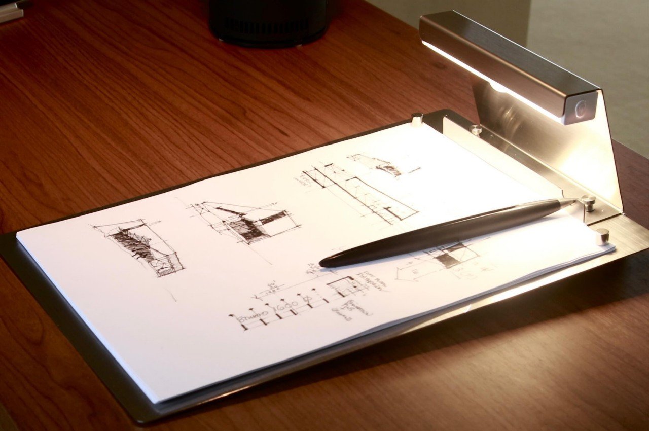 Ultra-minimalist clipboard made from a sheet of metal has a built-in light