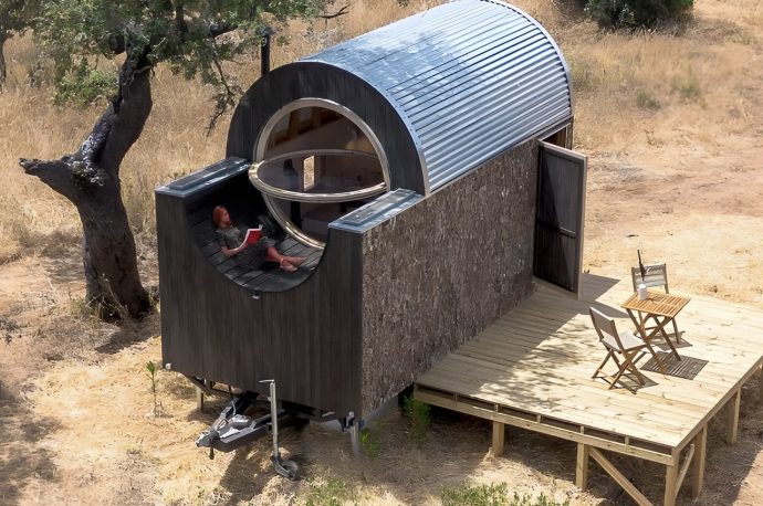 Wooden Tiny Home On Wheels Features A Curving Roof & A Snug Little Terrace For Relaxation