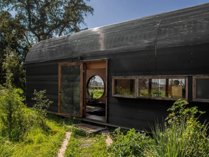 Vaulted Tiny Home Seems To Float Above The Ground, While Seamlessly Merging Indoors & Outdoors