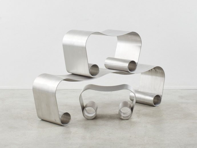 Scroll-like seats combine minimalism and brutalism in a mind-bending design