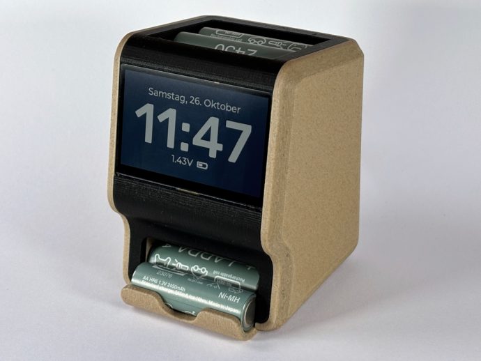 Cute 3D printed desk clock is an AA battery charger and dispenser
