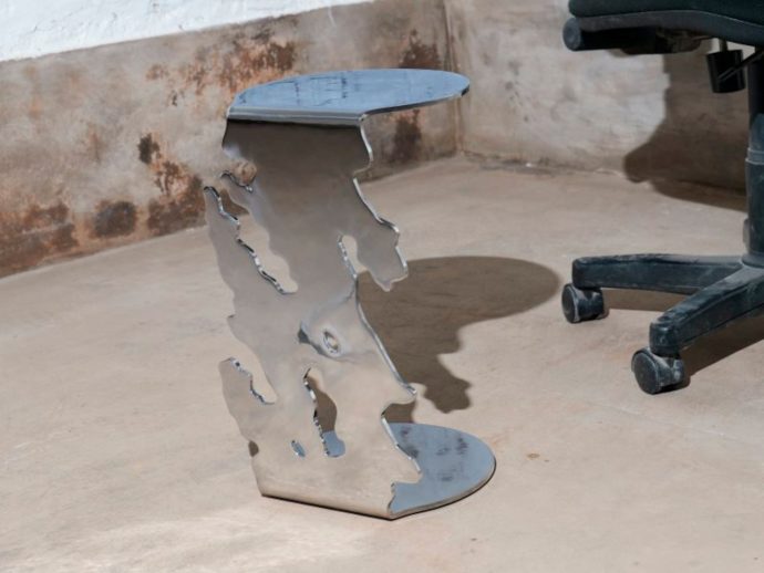 Structural side table adds a bit of tension and chaotic beauty to your space