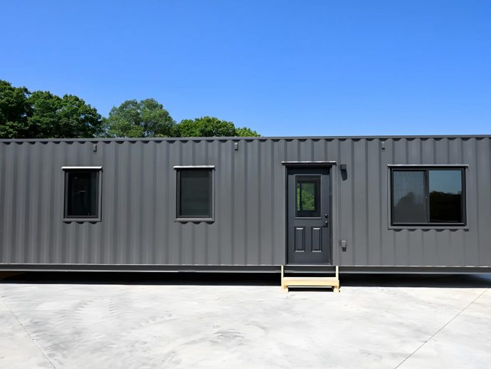 This ‘Iron Ore’-Colored Shipping Container Home Can Accommodate Humans & Vehicles Alike