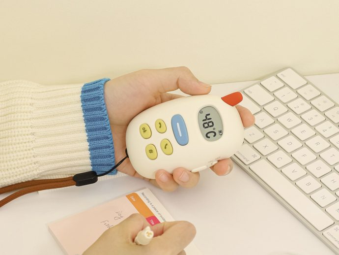 Cute pebble-shaped phone is a hand warmer that utilizes your bad habits