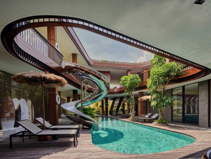 Playful Tropical Modern Home in Bali Features Slide, Central Void, and Serene Pool