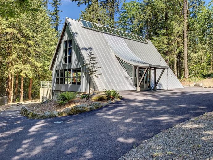 Steel & Glass A-Frame Home Shows Off Soaring Ceilings, Treehouse Deck, & A $1.8M Price Tag