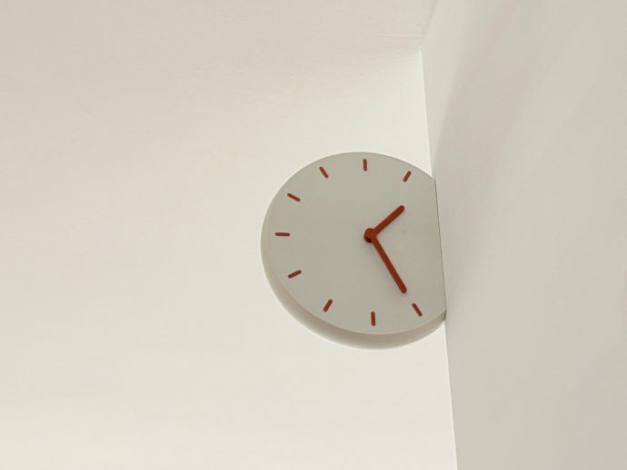 Corner Clock Peeks Around Walls for a Playful Time Twist