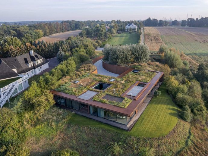 77 Studio’s Riverside Home Disappears into the Hillside Along Poland’s Vistula River