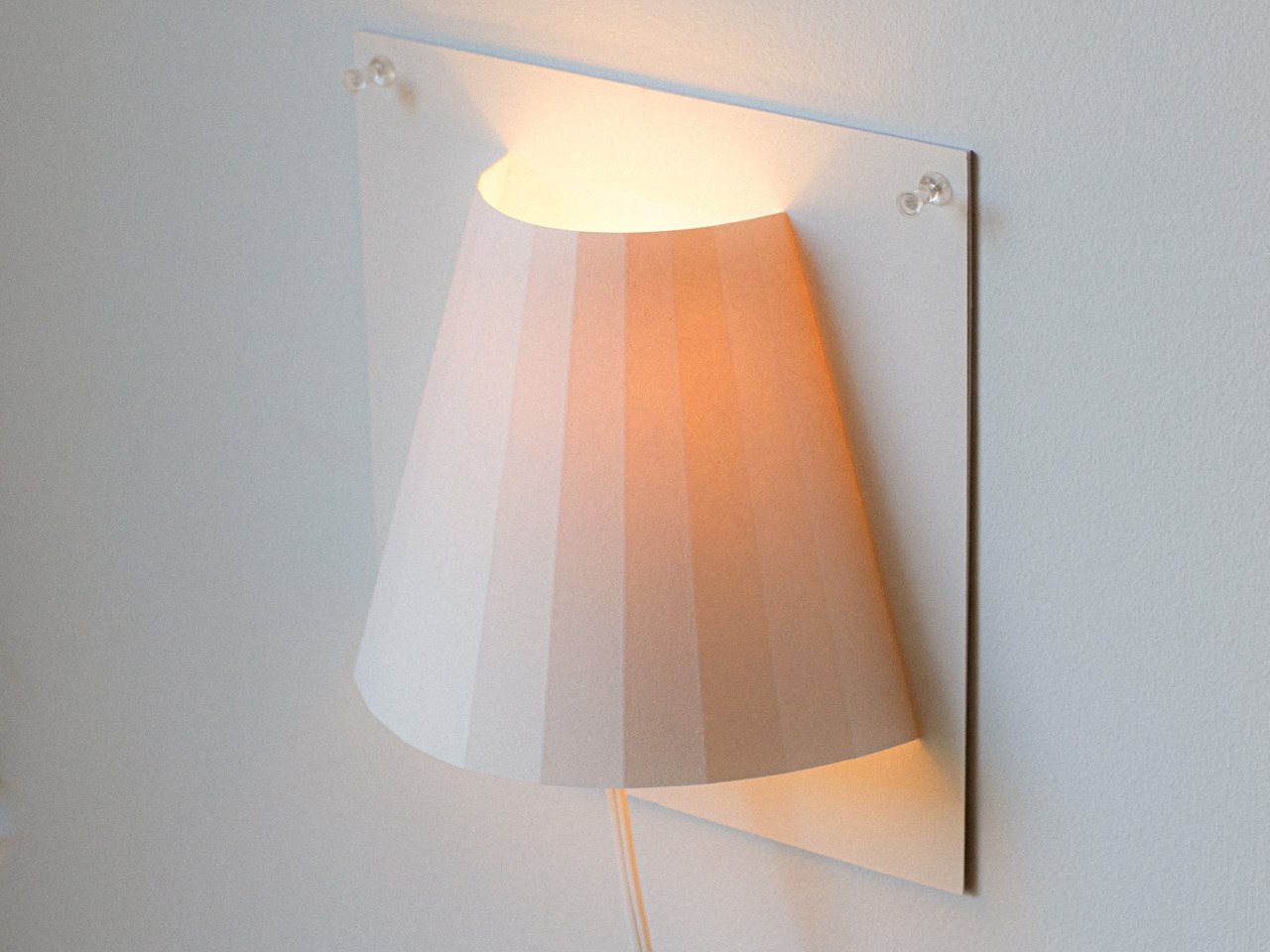 This Renter-Friendly Wall Lamp Mounts With Push Pins, Not Screws - Yanko Design