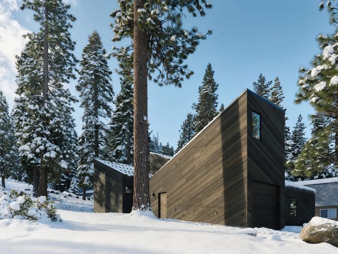 Four Dark Cedar Volumes Stepping Down a Tahoe Slope — This Is What a Smart Cabin Looks Like