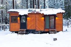This Off-Grid Mobile Tiny Home Has Two Full Workspaces & A Bedroom — & You Can Tow It Anywhere