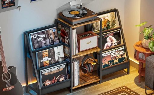 Home music corner with a turntable on top of a wooden rack and shelves full of vinyl records in a cozy room.