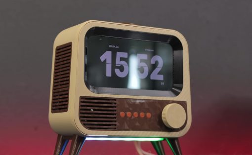 Retro tabletop radio with a large digital time display set to 15:52 and colorful LED underglow lights on a dark surface, mid-foreground view (informative image).