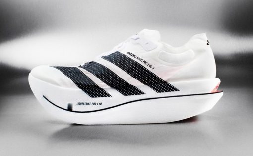 White running shoe with black dotted stripes and a thick curved sole, labeled Lightstrike Pro EVO.