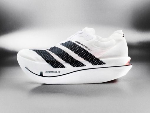 White running shoe with black dotted stripes and a thick curved sole, labeled Lightstrike Pro EVO.