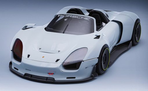 White futuristic Porsche race car with open cockpit, angled from the front-left, showing aerodynamic body and neon-green-wheel rims