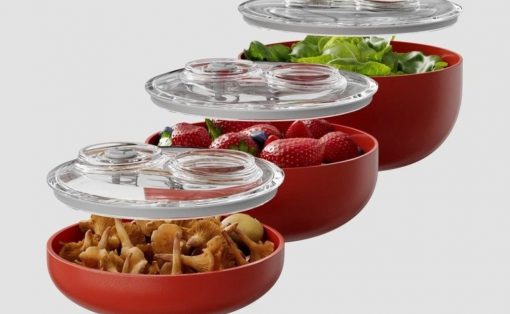 Stackable red food storage bowls with airtight clear lids, shown with mushrooms in the bottom bowl, then strawberries, greens, and a salad above.