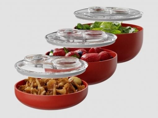 Stackable red food storage bowls with airtight clear lids, shown with mushrooms in the bottom bowl, then strawberries, greens, and a salad above.