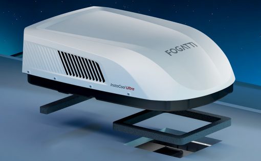 Sleek white rooftop air conditioner unit labeled Fogatti InstaCool Ultra mounted on a vehicle roof against a night sky.