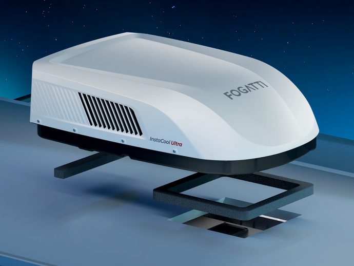 Sleek white rooftop air conditioner unit labeled Fogatti InstaCool Ultra mounted on a vehicle roof against a night sky.
