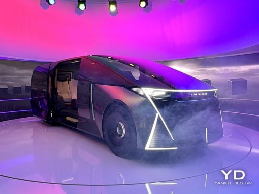 Futuristic concept minivan on a circular display platform with pink-purple lighting and smoke, angular LED front, YD Yanko Design watermark.