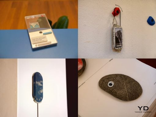 Collage of four product shots: a vintage smartphone on a blue surface, a phone hanging from a keychain on a wall, a blue-bordered phone mounted on white, and a stone-like device with a camera lens on a page marked 'YD Yanko Design'
