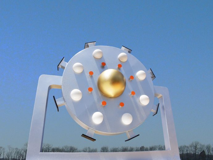 Outdoor circular metal sculpture with a gold central sphere and surrounding white lights against a blue sky, mounted on a white frame.