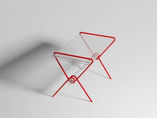 Modern red metal folding chair with clear acrylic seat and back, viewed from an angled side.