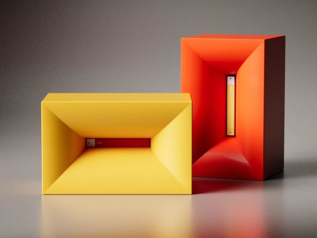 Two hollow rectangular prisms, yellow in front and orange-red behind, with concave inner walls and slim inserted bars visible inside each.