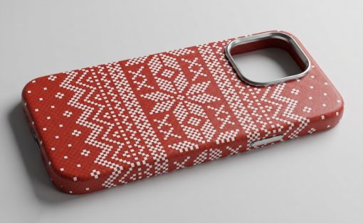 Red phone case with a white knitted Nordic pattern and a circular metal camera cutout, laid on a light gray surface.