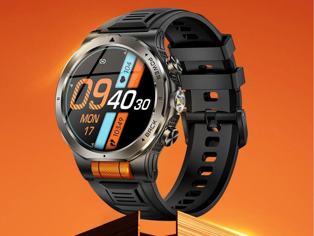 Rugged black and orange sports smartwatch with a round colorful display on an orange background, showing time and date