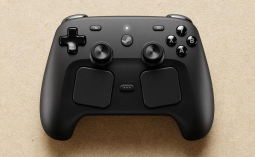Black wireless game controller resting on a beige textured surface, featuring a D‑pad, two analog sticks, four face buttons (A, B, X, Y) and a center Steam button.