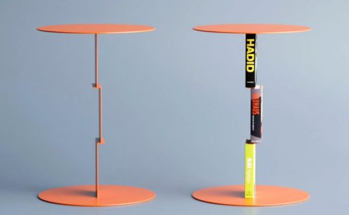Two orange circular display stands; the left is empty, the right holds a vertical stack of books.