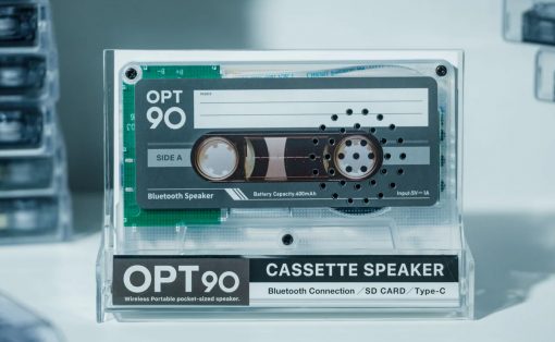 Transparent display of an OPT90 cassette speaker in a clear case, with 'CASSette SPEAKER' and 'Bluetooth Connection' labels visible.