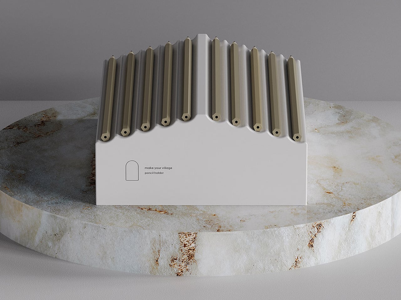 White rectangular pencil holder with numerous beige pencils standing upright on a circular marble pedestal.