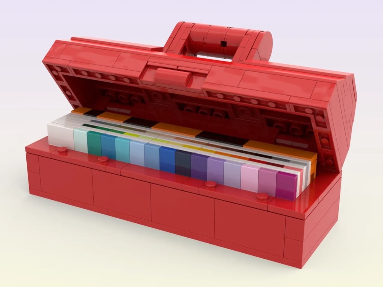 Red LEGO printer model with open lid revealing rainbow color cartridges inside, set on a light surface