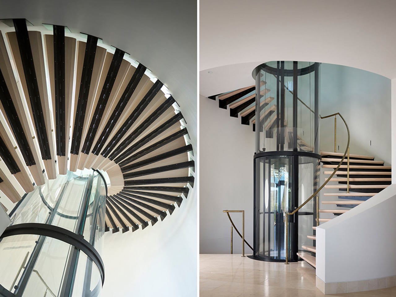 Top-down view of a modern spiral staircase with black treads and a glass railing, forming a circular pattern in a white space.