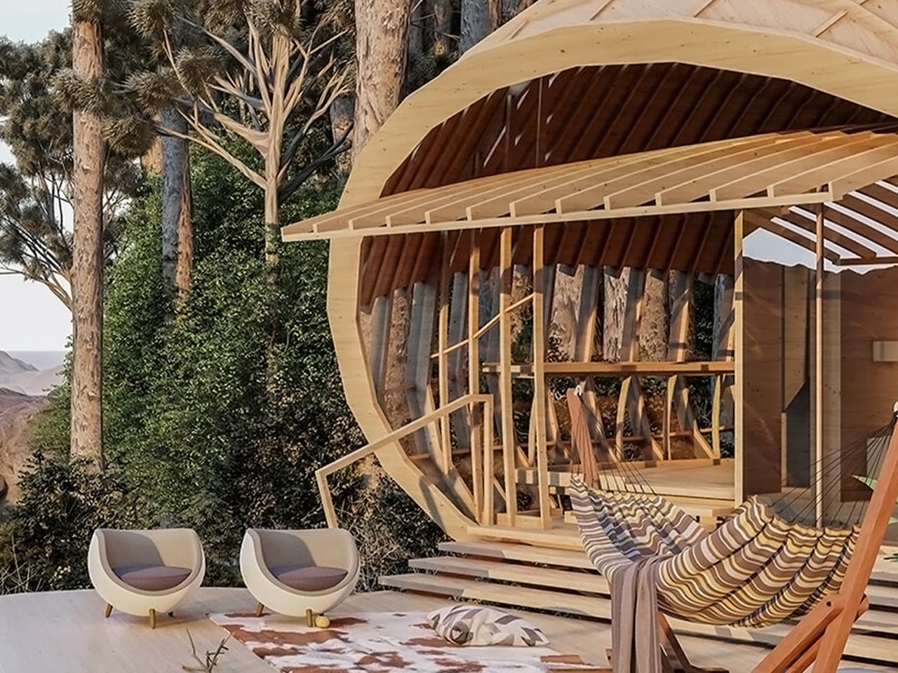 Circular wooden pavilion under construction on a deck with striped hammock, two modern chairs, and cushions amid trees and desert mountains in the background.
