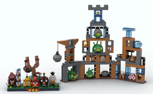 LEGO Angry Birds display with colorful birds on a baseplate and a multi-level pig-filled fortress on the right.