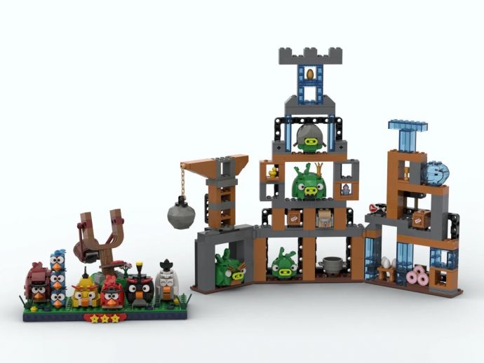 LEGO Angry Birds display with colorful birds on a baseplate and a multi-level pig-filled fortress on the right.