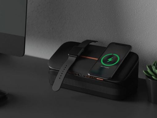 Black wireless charging dock powering a smartwatch and an iPhone; the phone shows a green charging indicator at 95%.