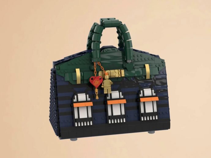 LEGO handbag built from dark blue and green bricks with a top handle and a red heart lock charm.
