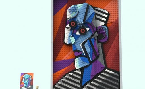 Large framed LEGO mural of a geometric blue portrait with an orange-purple background.