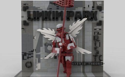 LEGO-style winged warrior in red and white holds a tall red staff before a gray wall that reads 'Hybrid Theory'.