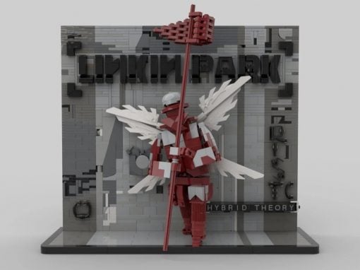 LEGO-style winged warrior in red and white holds a tall red staff before a gray wall that reads 'Hybrid Theory'.
