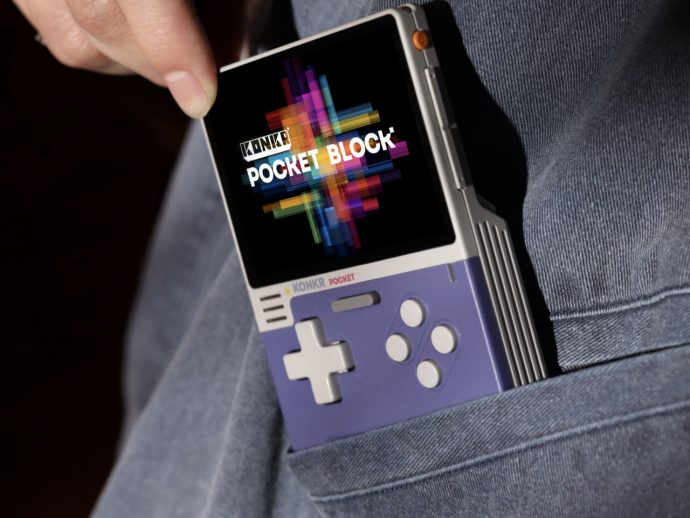 Retro handheld gaming console poking out of denim pocket, screen shows colorful 'Pocket Block' graphic and KonKR branding.