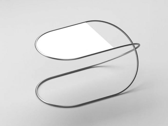 Abstract close-up of a metallic stethoscope coiled into looping shapes on a gray background, minimal and modern.