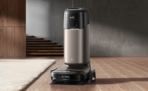 Eufy robot vacuum on its charging dock in a modern living room with wooden floor and neutral walls