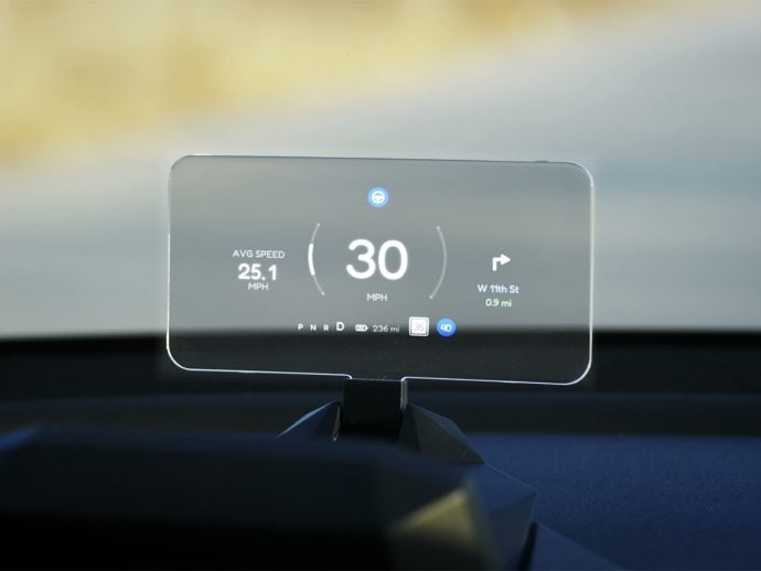 Head-up display showing 30 mph, avg 25.1 mph, and a turn onto W 11th St, 0.9 mi ahead.